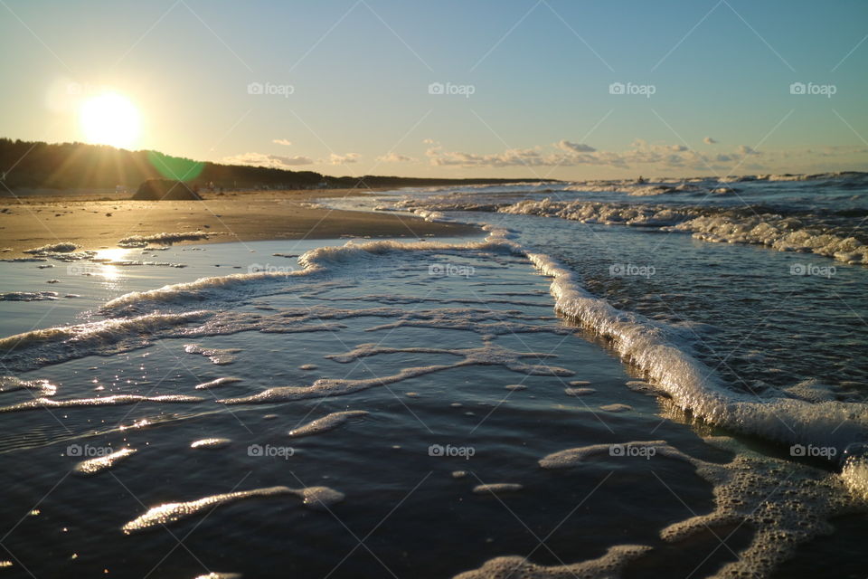 Waves in the sunset on the beach in Karlshagen on the island of Usedom in Germany in summer