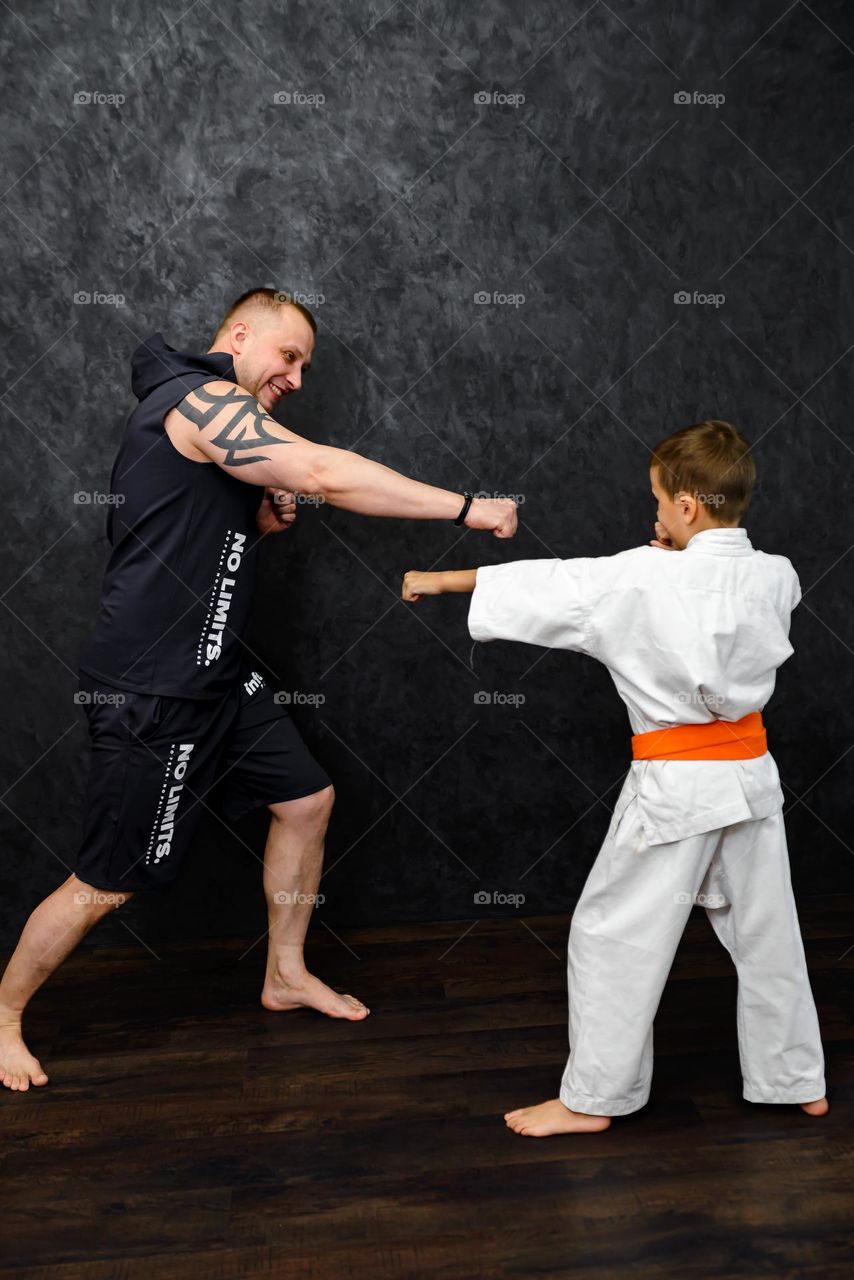 Father and son athletes training karate