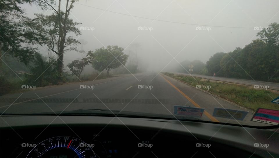 Smoky highway. Forest fire created a great smoke to highway in northern province of Thailand