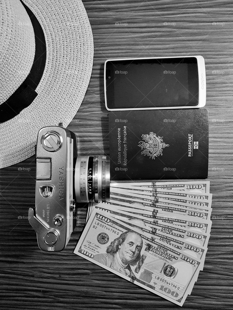 traveling preparation hat, vintage reflex analogue camera, passport and dollars