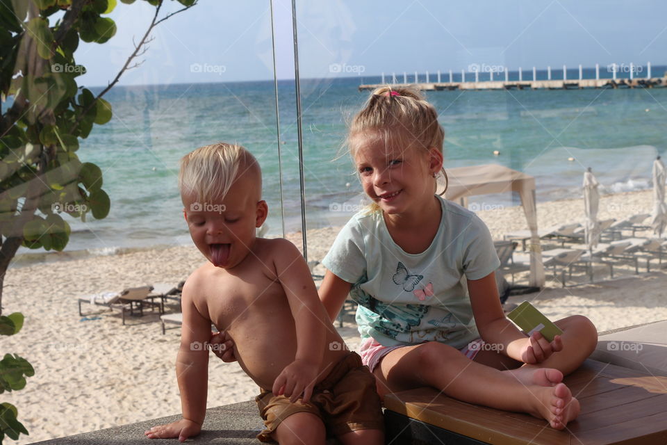 Siblings having fun at the beach 