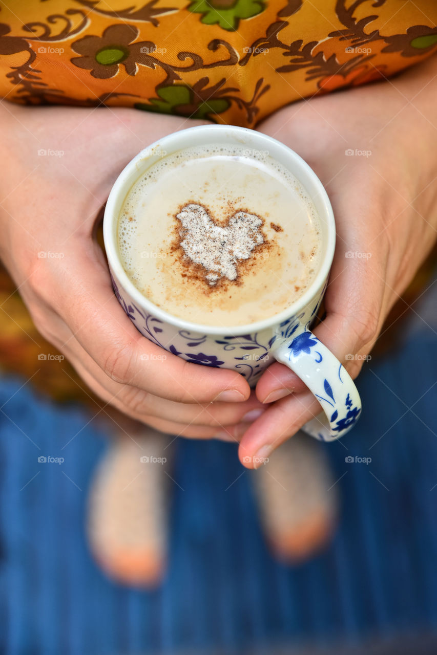 Person holding cup of coffee