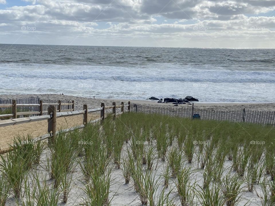 A photo of the beach, dunes and ocean in Bay Head, NJ taken on a September day. September is a great time to enjoy the tranquility of the beach without the summer crowds although, to me, the beach is enjoyable year-round.