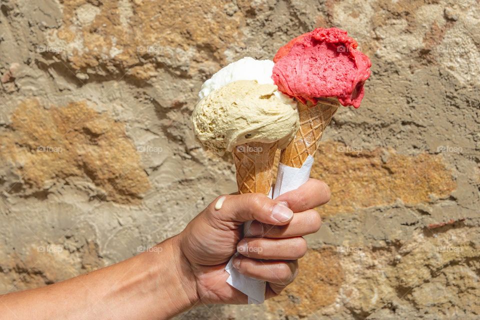 hand with two ice cream cones