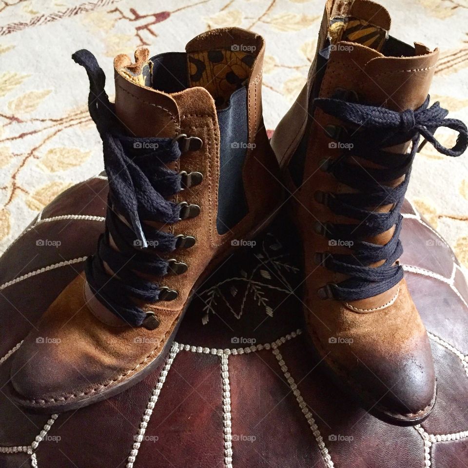 Boots on ottoman 