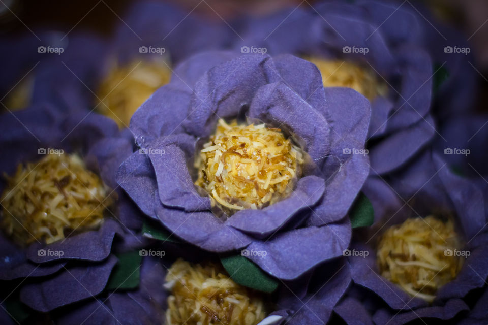 Coconut sweet in a purple flower candy mold