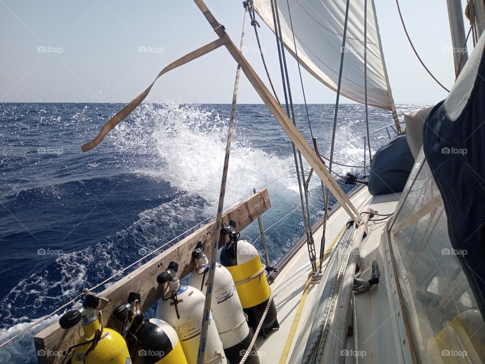 Upwind Sailing, beating through the Waves and taking Sea Spray over our Yacht Deck and Scuba Air Cylinders on our Ocean Voyage/Passage from Sardinia to Mainland Italy.