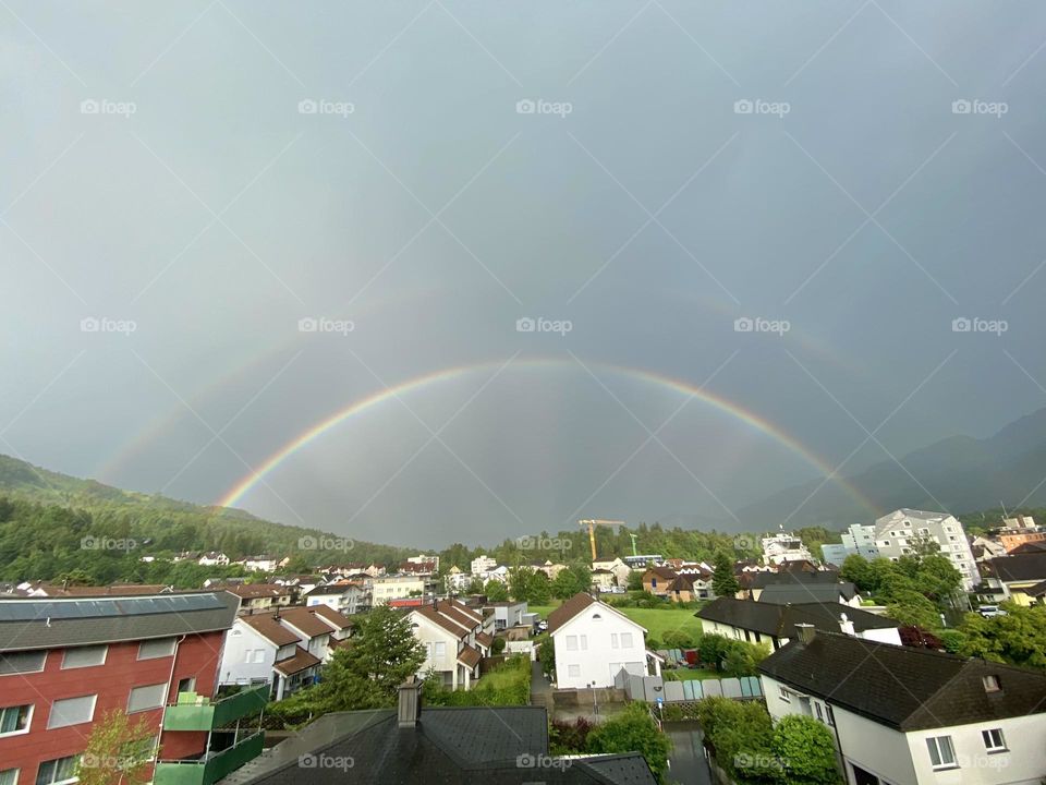 double beautiful rainbow after rain over the city in switzerland
