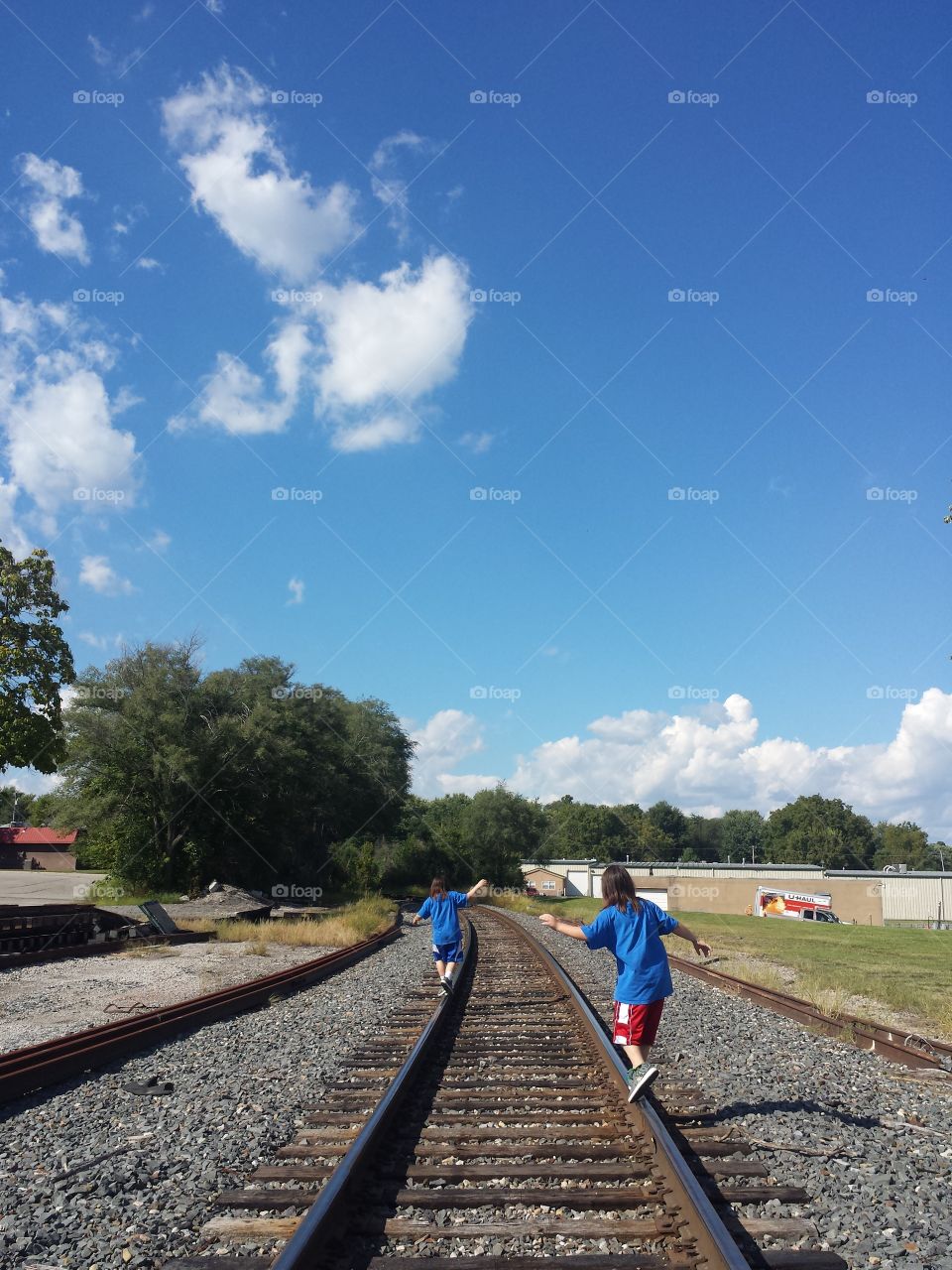Twins Balancing on the Tracks