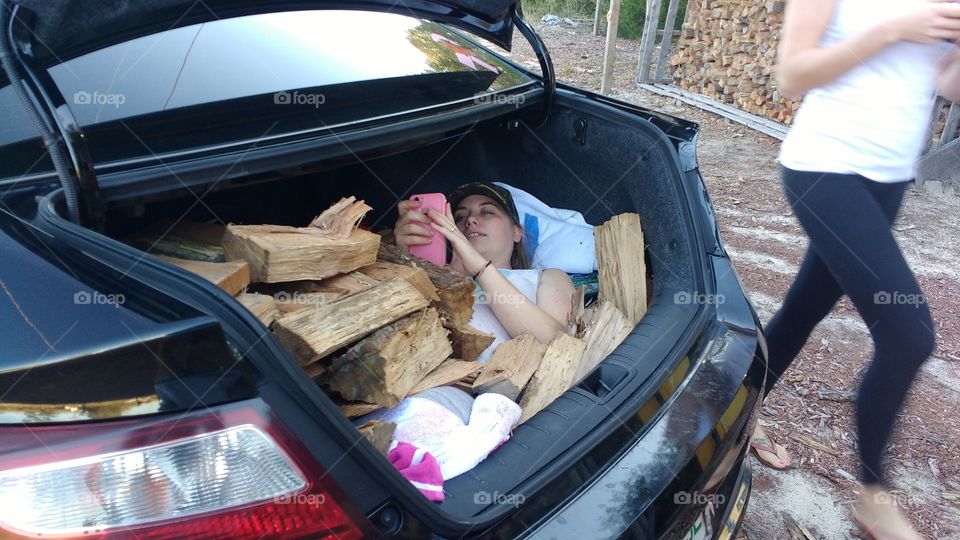 woman bury under wood in the trunk of a car