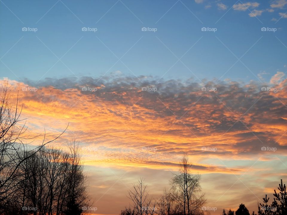 sunset with orange sky and dark clouds
