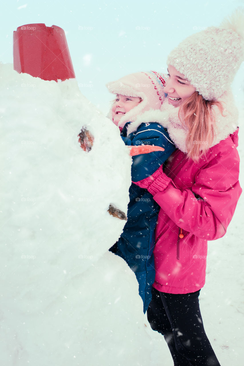 Winter with friends. Spending wintertime outdoors playing with snow