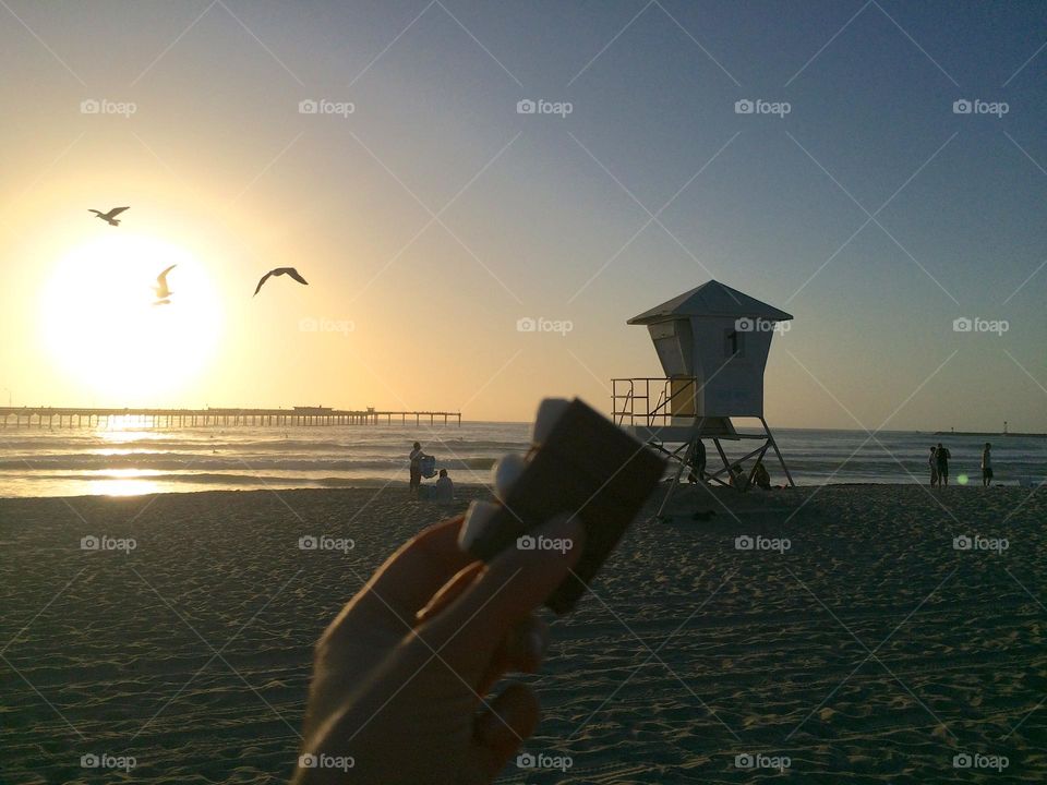 Enjoying panoramic coastline nature views and s'mores during blissful evenings in Ocean Beach, California. 