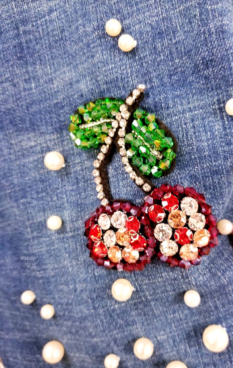 Hand made cherry applique of beads on jeans