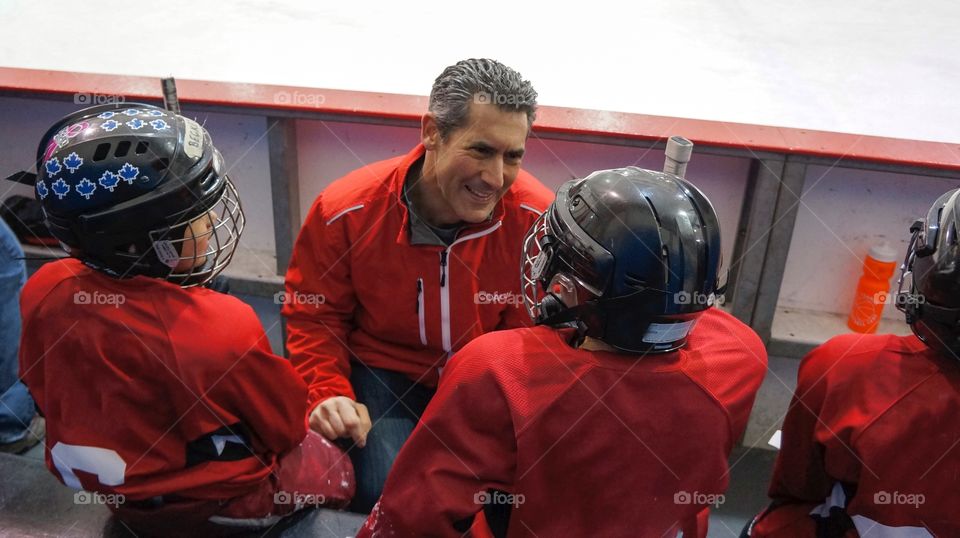 Hockey Coach talking to His Players 