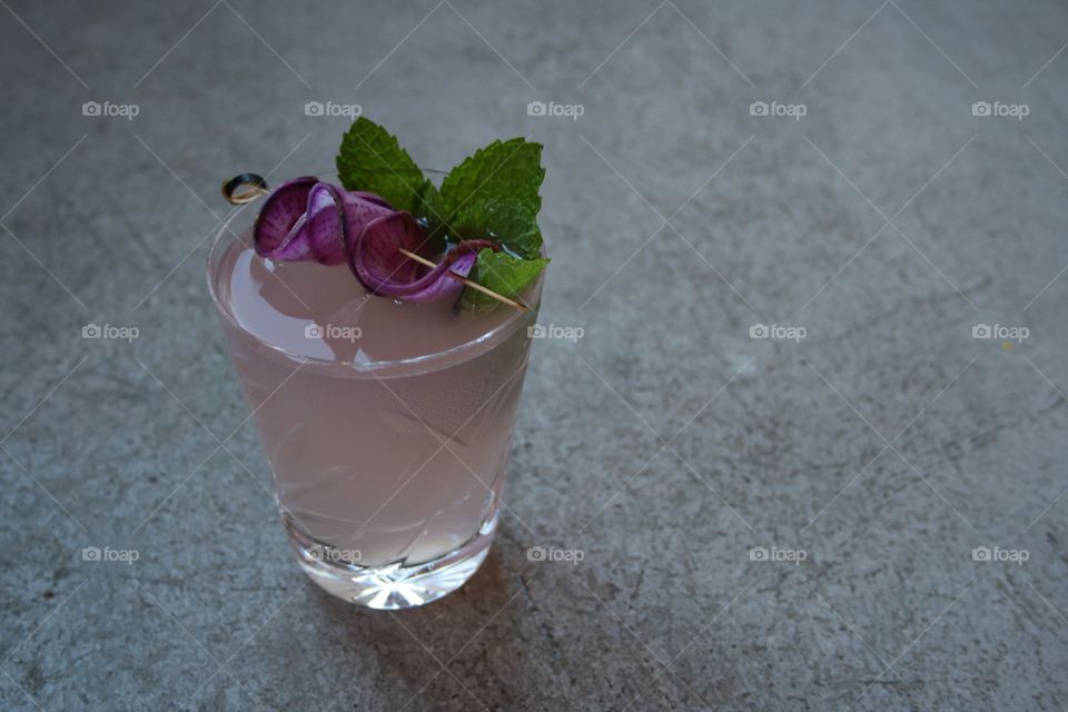 Purple cocktail with radish garnish 