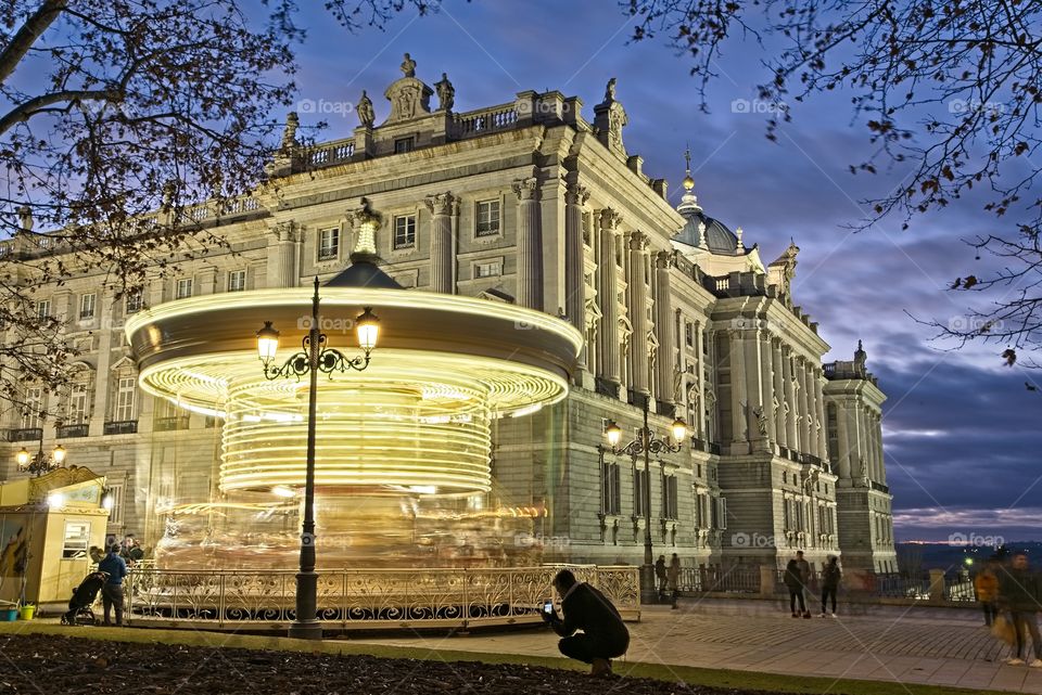 Carousel in front of Royal Palace in Madrid at dusk