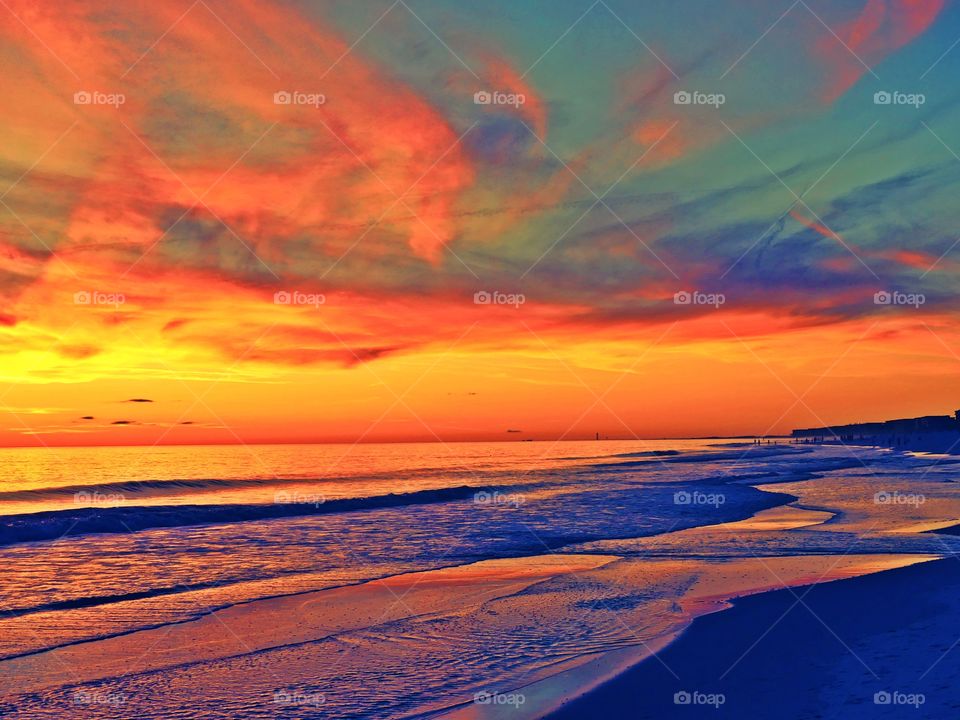 Nature at its best. A kaleidoscope of colors swirl above a reflective Gulf of Mexico. 