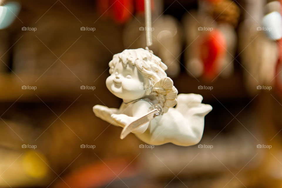 Porcelain angel figure on a blurry background