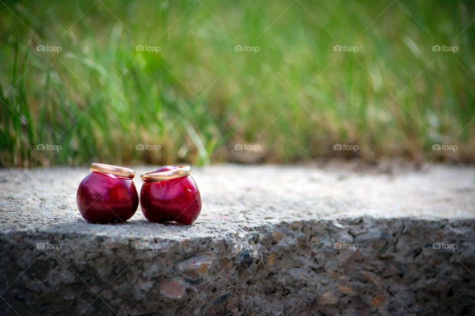 wedding rings. two cherries in ring-hats