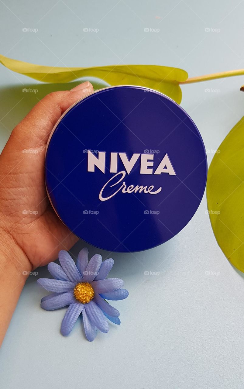 circle shaped nivea cream in hand