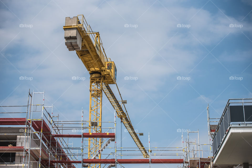 view of the construction site, scaffolding and crane