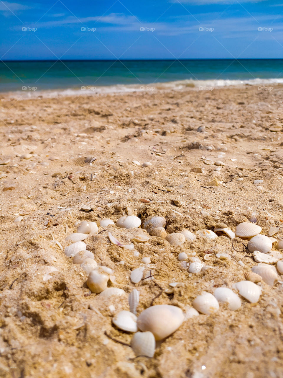 blue beach landscape with a heart in the orange sand