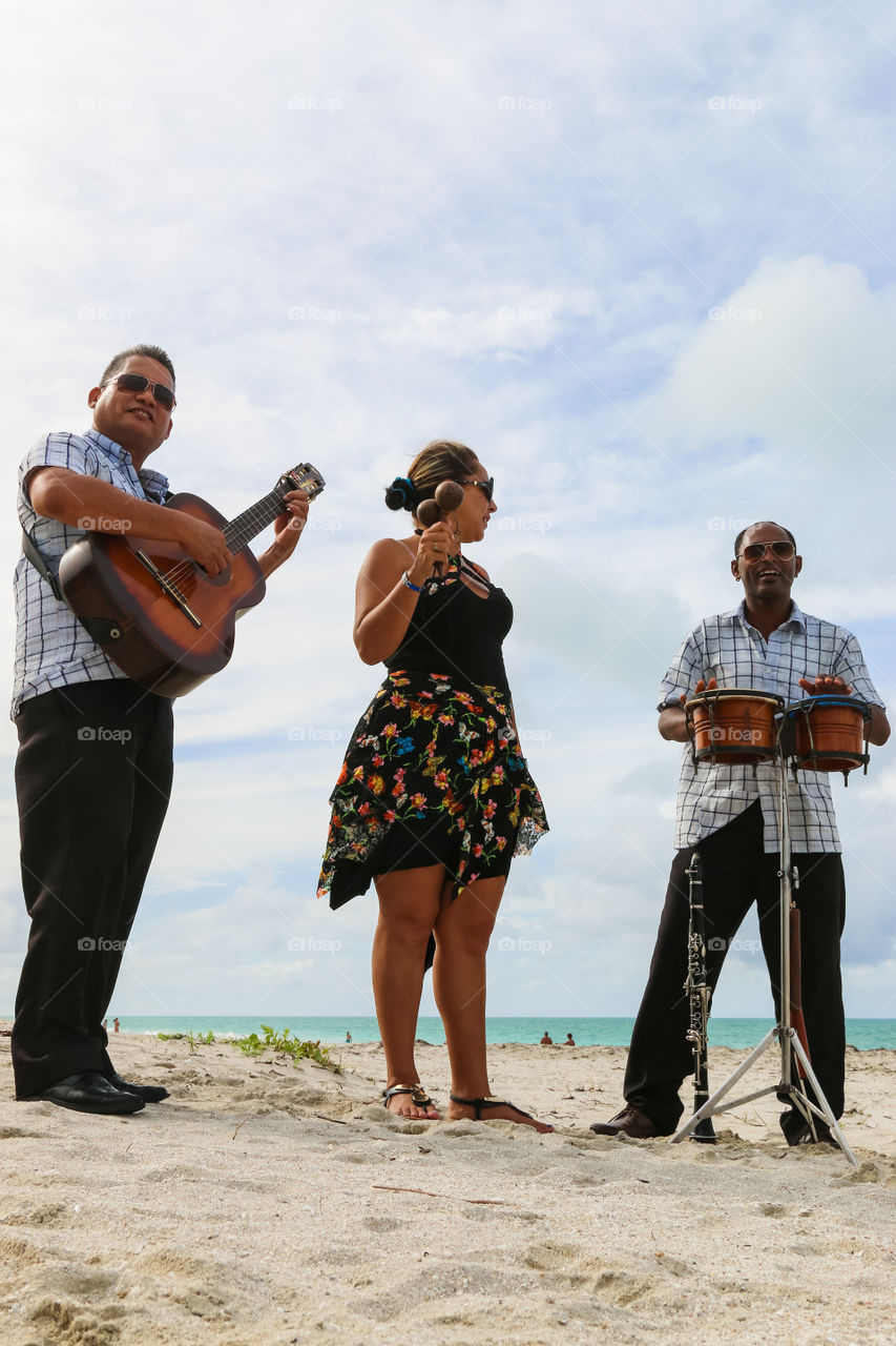 Trio ensemble performing on the beach, Cuba, Varadero