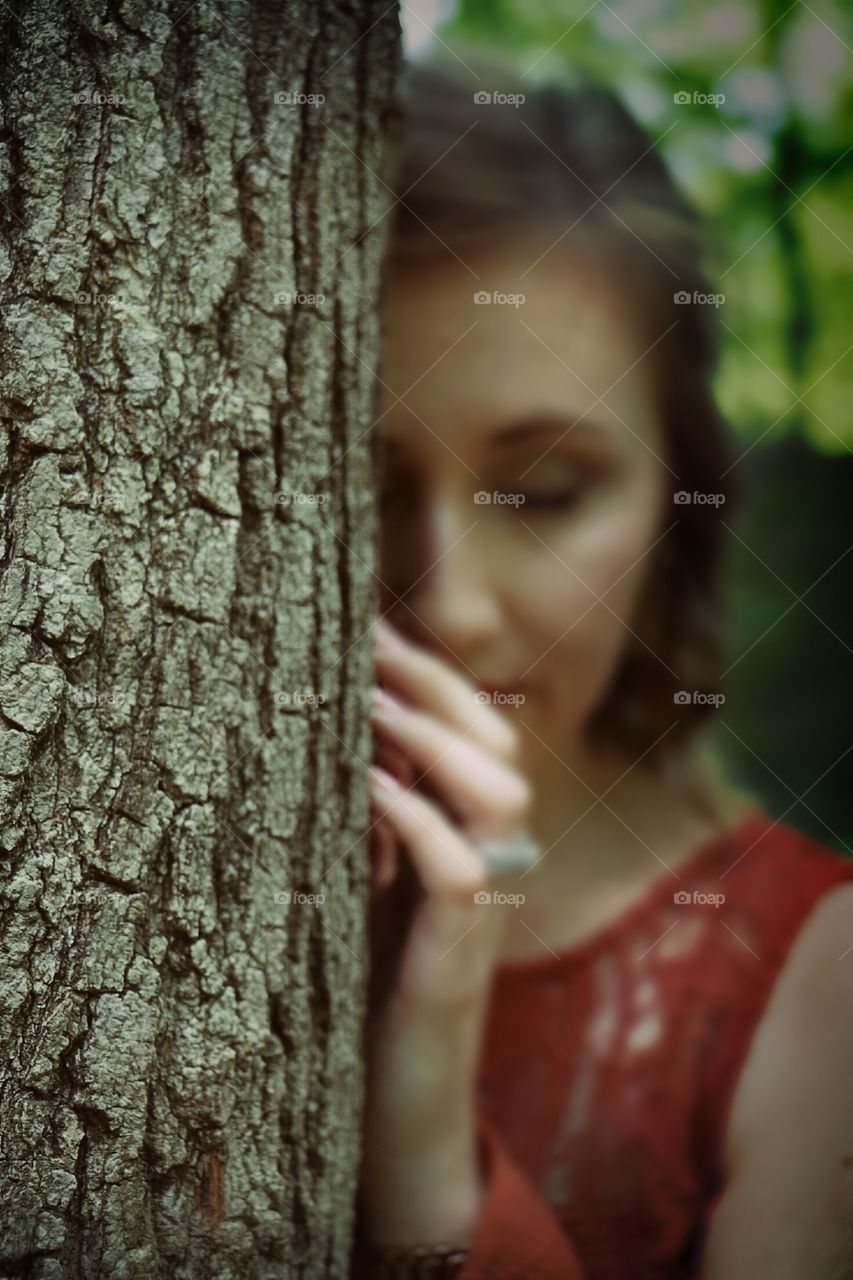 Girl behind tree