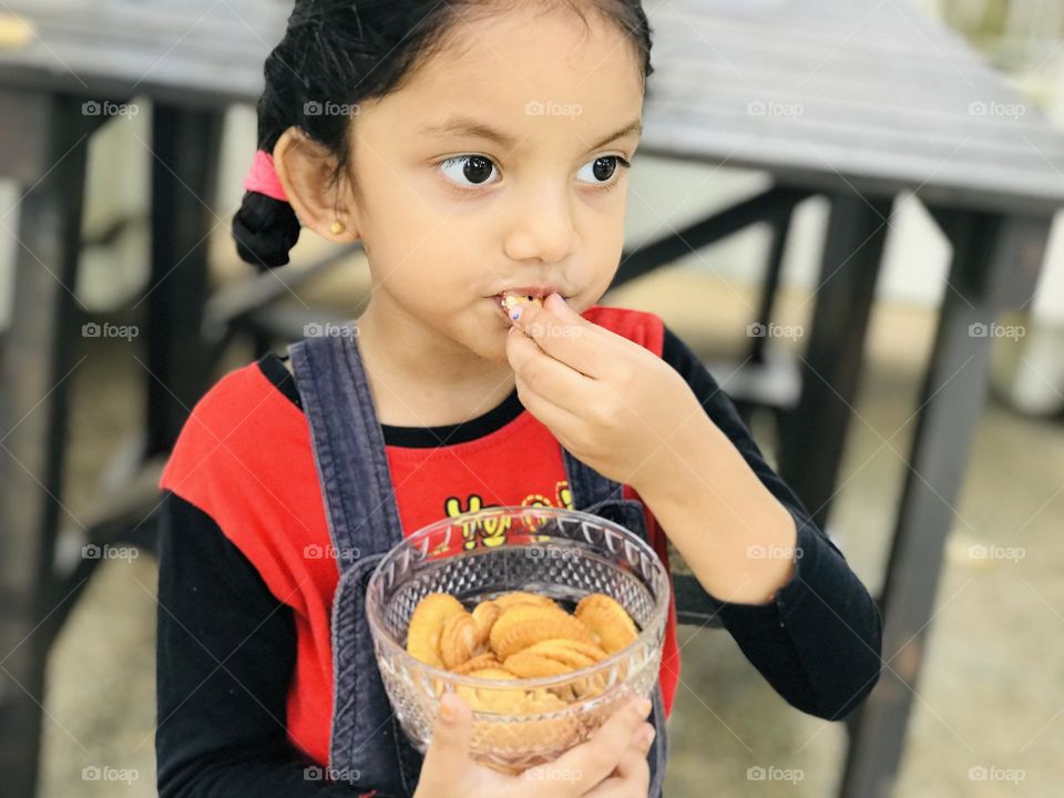 Baby girl eating cookies 