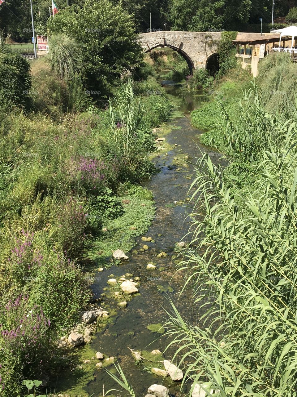 Little river with old Roman bridge 