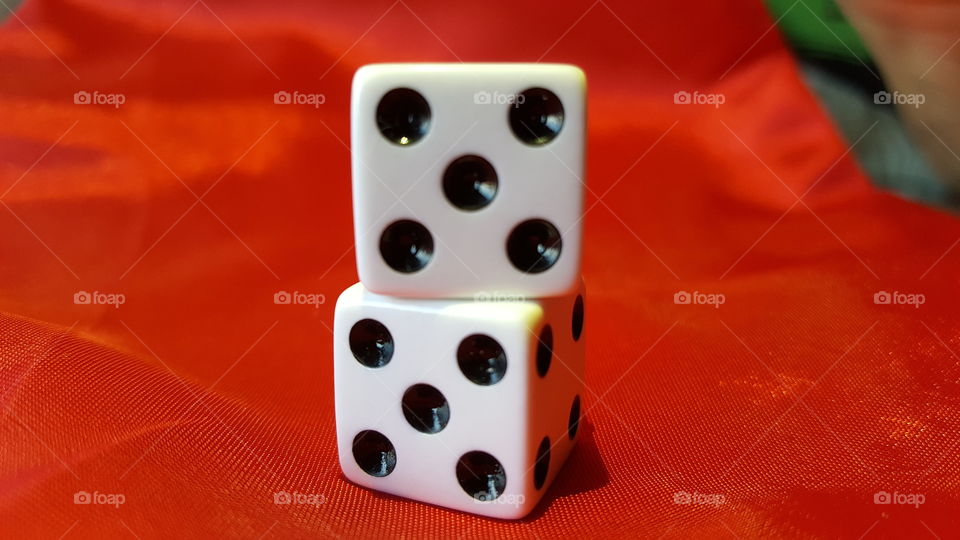 Two dice against red backgrounds