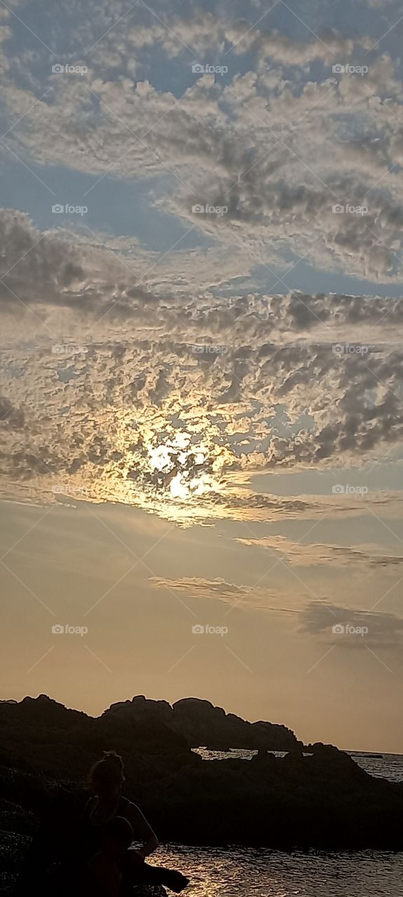 sun behind clouds