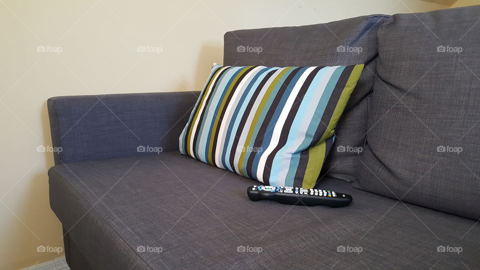 empty couch with remote