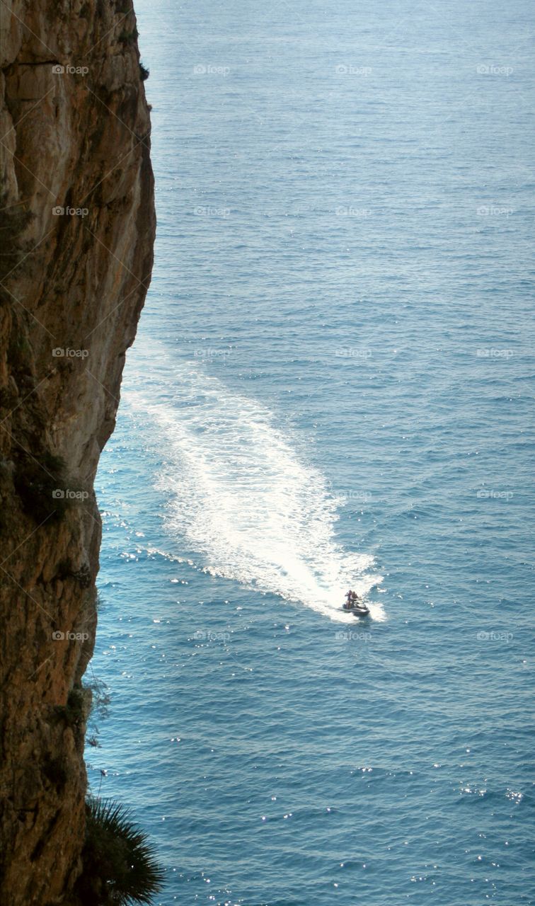 Jet skis passing just under the headland