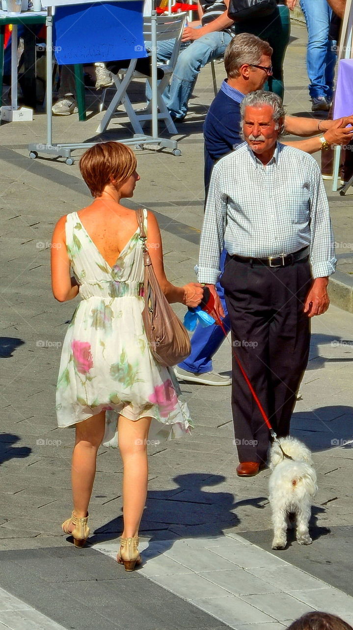 young woman walking with a little dog