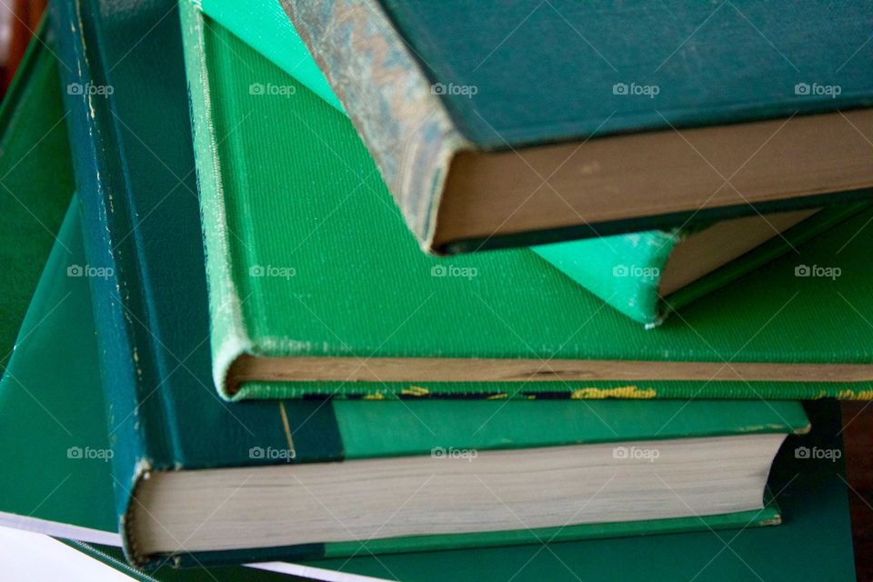 Green Color Story - stacked books with various shades of green covers 