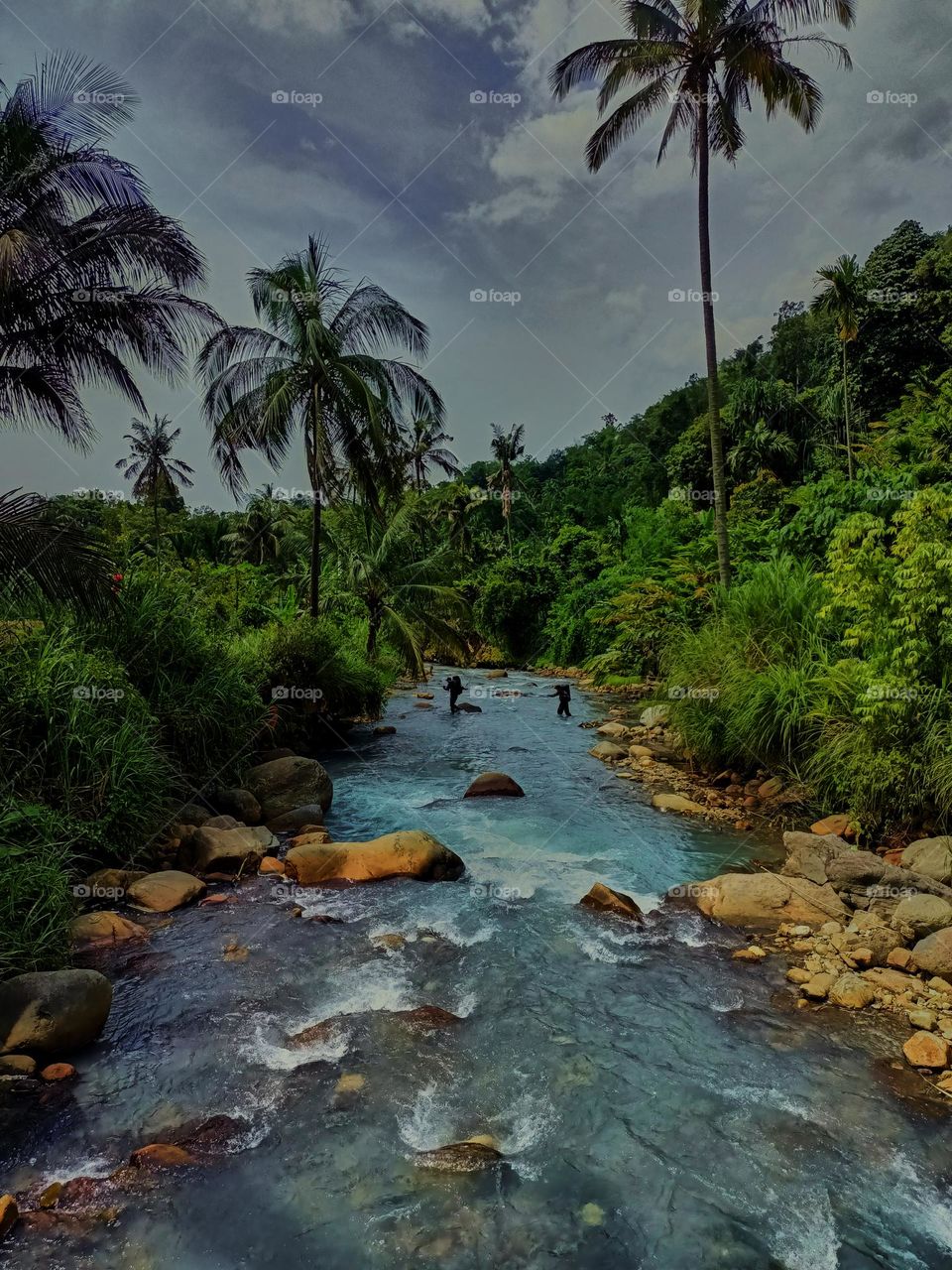 Panoramic landscape of bright blue river of dua rasa river and tropical rain forest