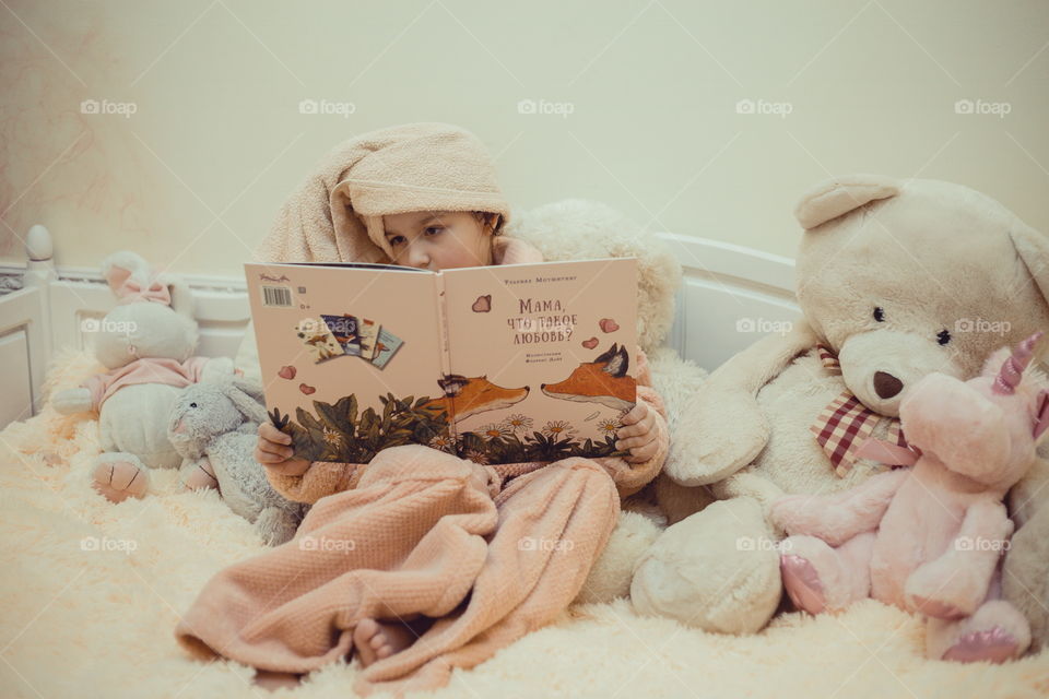 Girl in bathrobe reading the book 