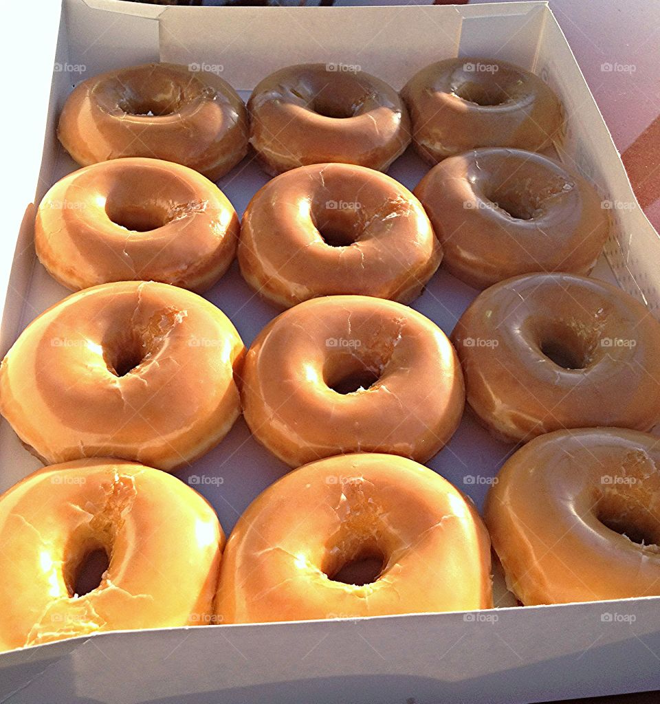 Hot krispy kreme donuts in the bright morning sun