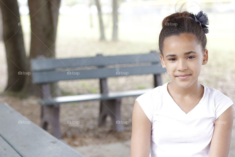 TEEN GIRL ON PARK BENCH