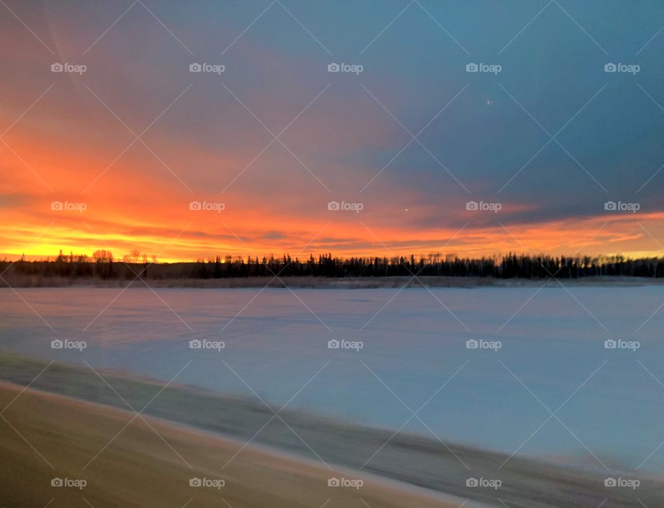 Winter sunsets are so colorful and look warm in spite of the coldness. I think this one is in Canada. 