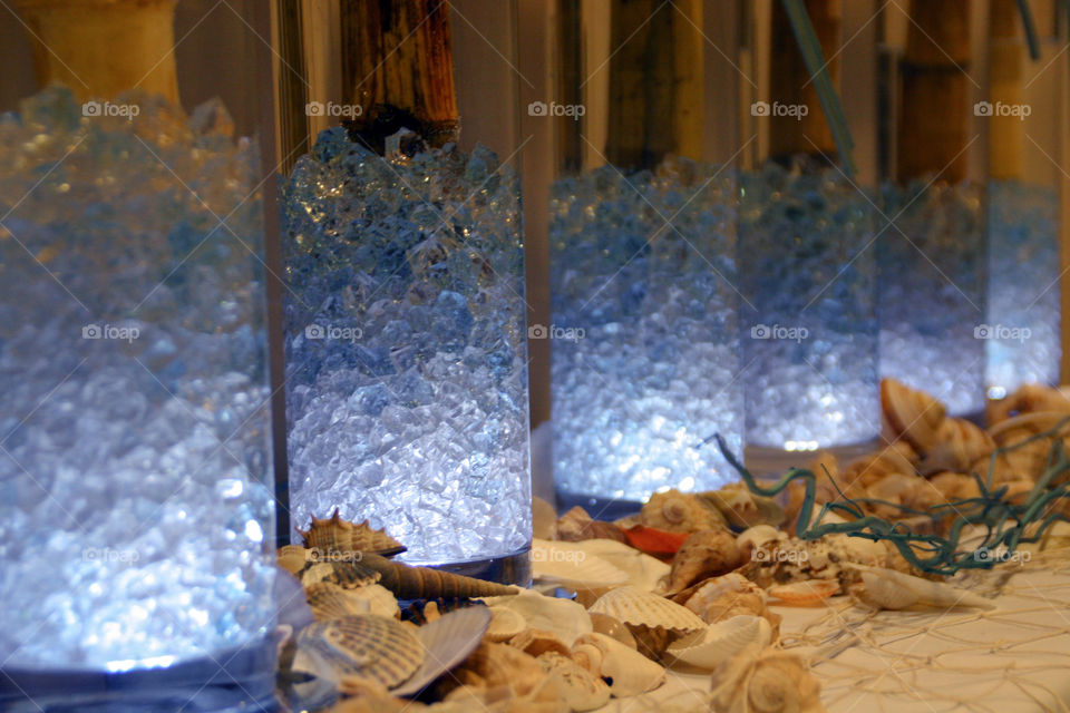 Illuminated glass vases at an event