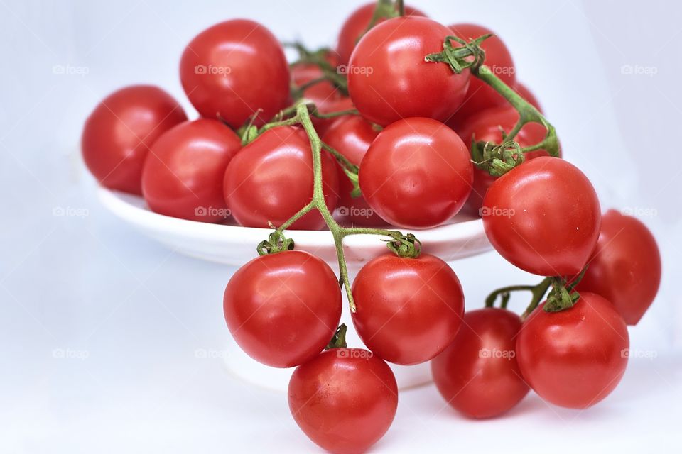 Red tomatoes in a white plate