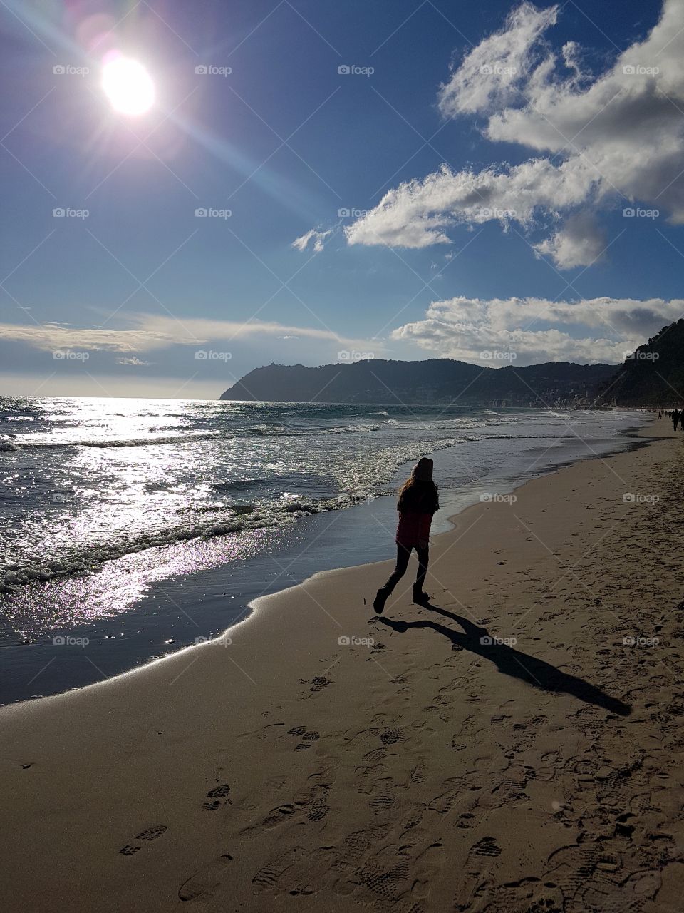 Girl on the beach in a sunny sprin day in italian Riviera