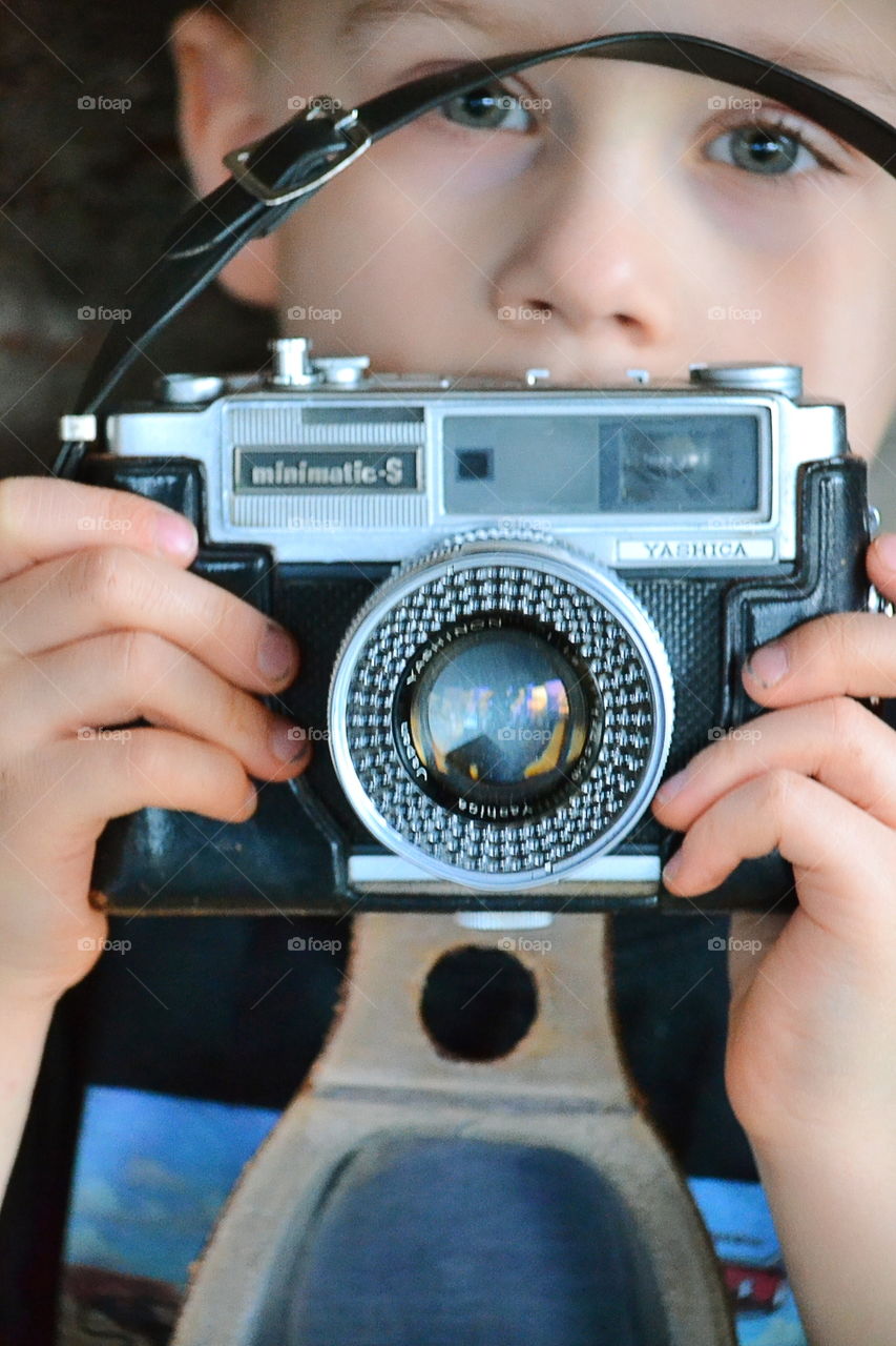 Boy with a vintage camera