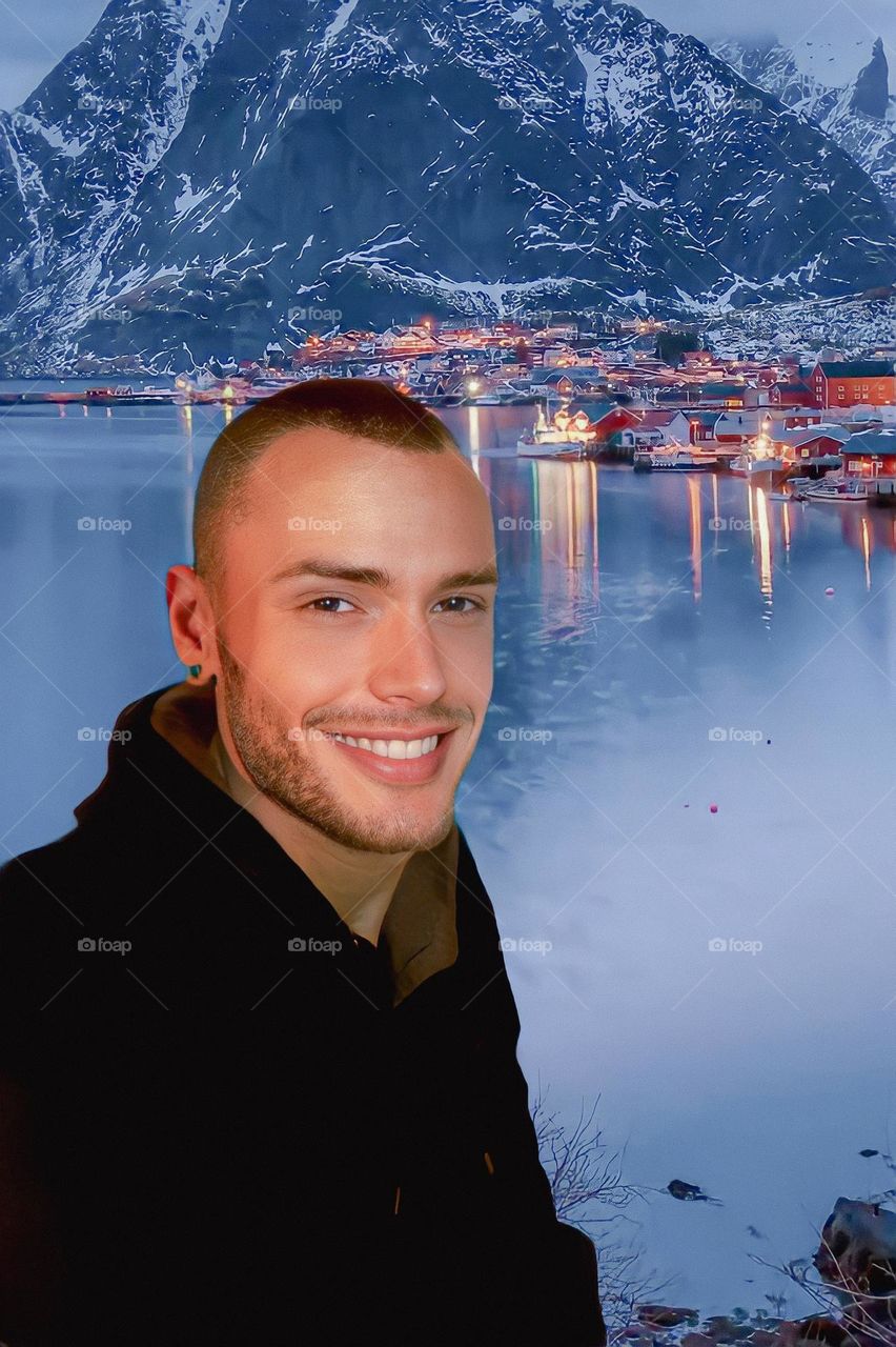 Selfie smiling next to water and mountains 