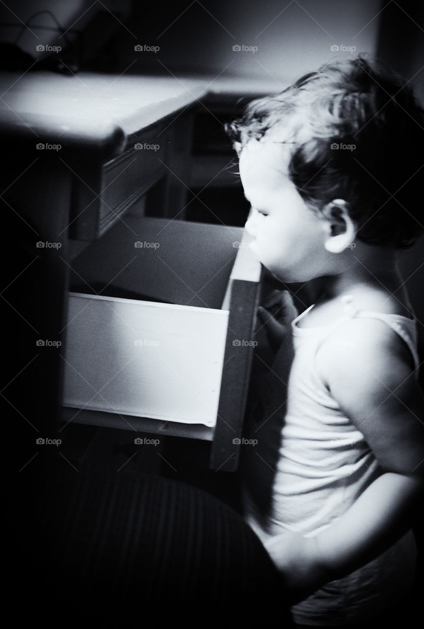 Baby girl looking inside drawer