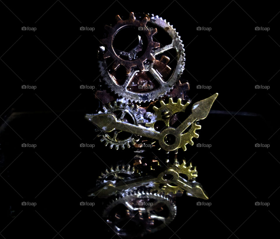 Clockwork in reflection on a black background