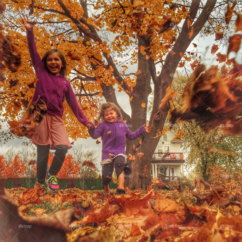 Sisters enjoying in park during autumn